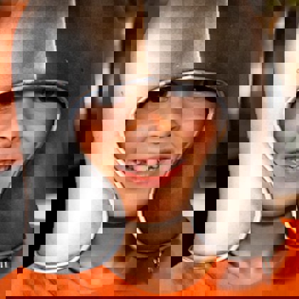 two children trying on medieval style battle helmets 