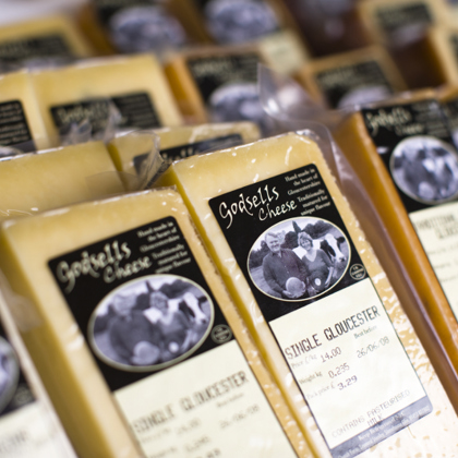 rows of packaged cheeses