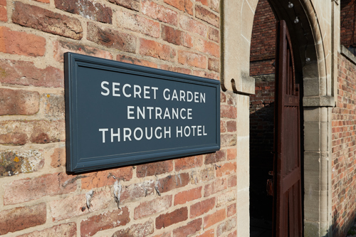 Secret Garden Through Hotel Sign